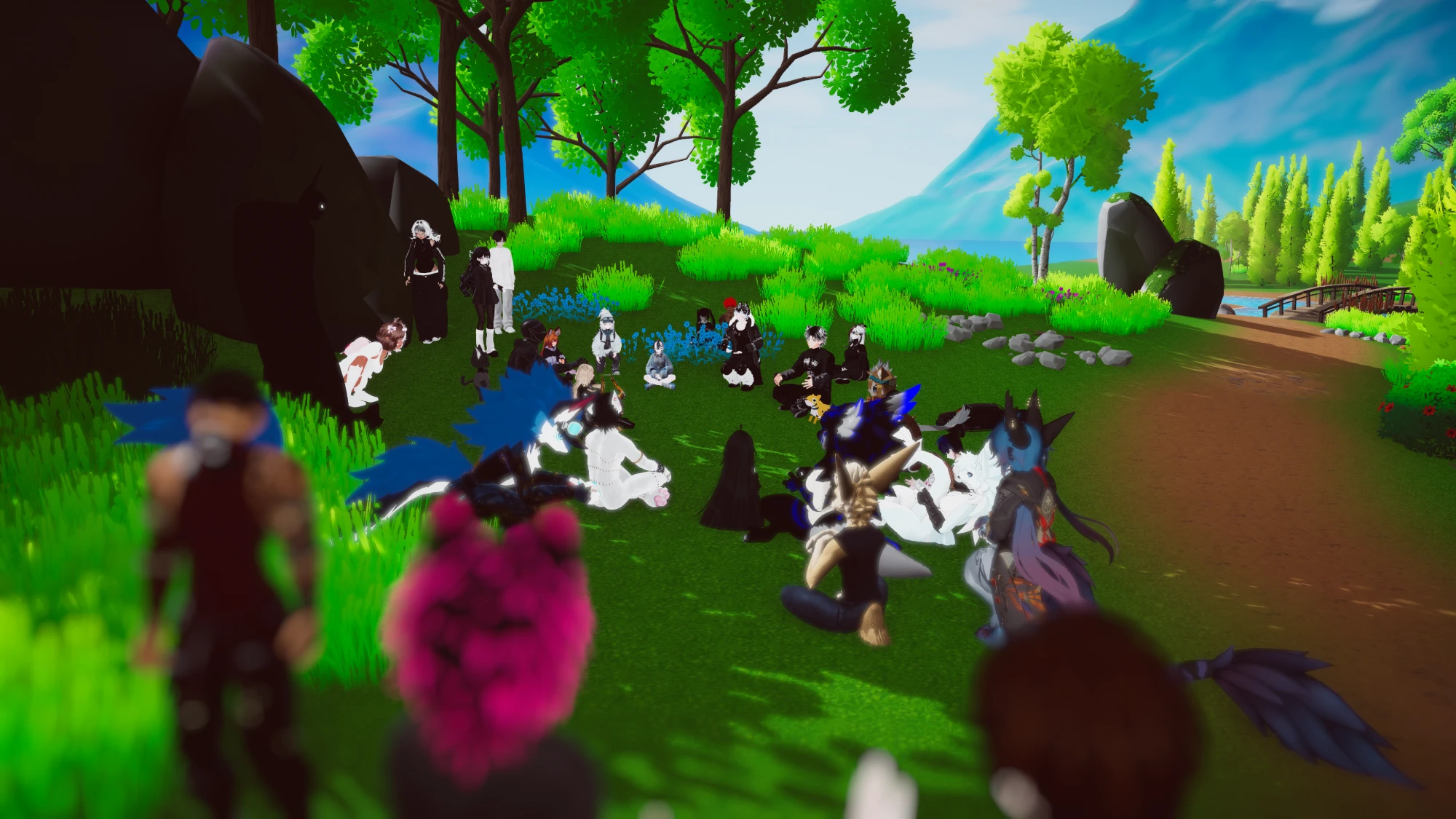 A Bible reading in the Meta Church VR world: around twenty avatars of every kind sitting in a loose circle on the grass between trees and boulders, with a lake and mountains behind.